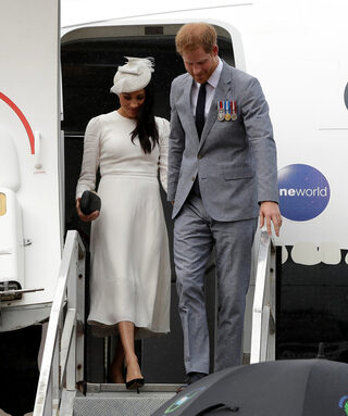 Britain's Prince Harry and Meghan, Duchess of Sussex, disembark from their plane upon their arrival in Suva