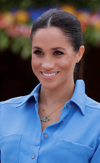 Britain's Meghan, Duchess of Sussex smiles during a visit to Tupou College in Tonga