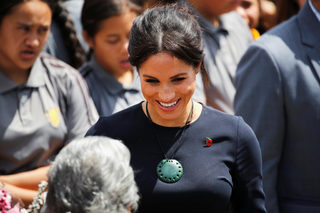 Britain's Meghan, the Duchess of Sussex talks to people after a formal powhiri welcoming ceremony and luncheon in Te Papaiouru
