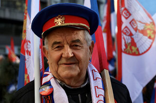 People display Serbian flags during the visit of Russian President Vladimir Putin in Belgrade