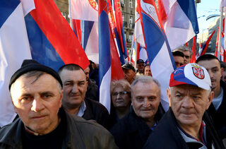 People display Serbian flags during the visit of Russian President Vladimir Putin in Belgrade