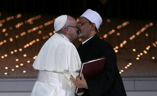 Pope Francis and Grand Imam of al-Azhar Sheikh Ahmed al-Tayeb kiss each other after signing a document on fighting extremism, during an inter-religious meeting at the Founder's Memorial in Abu Dhabi