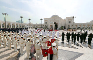 Pope Francis stands next to Vice-President of UAE and ruler of Dubai Sheikh Mohammed bin Rashid al-Maktoum, and Abu Dhabi's Crown Prince Mohammed bin Zayed Al-Nahyan during a welcome ceremony at the Presidential Palace in Abu Dhabi