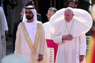 Pope Francis stands next to Vice-President of UAE and ruler of Dubai Sheikh Mohammed bin Rashid al-Maktoum during a welcome ceremony at the Presidential Palace in Abu Dhabi