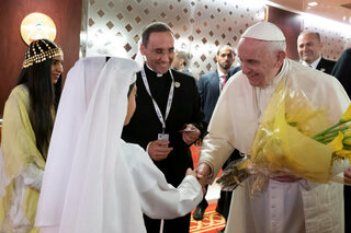 Pope Francis, Head of the Catholic Church is greeted by an Emirati boy upon his arrival at Abu Dhabi International airport in Abu Dhabi