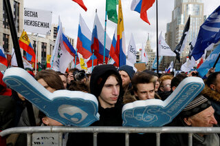 People attend a rally to protest against tightening state control over internet in Moscow