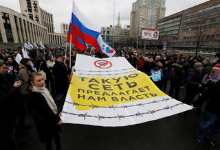 People attend a rally to protest against tightening state control over internet in Moscow