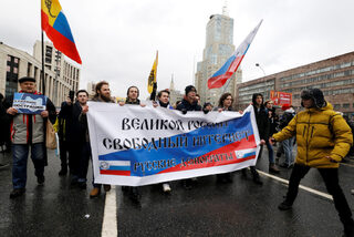 People attend a rally to protest against tightening state control over internet in Moscow