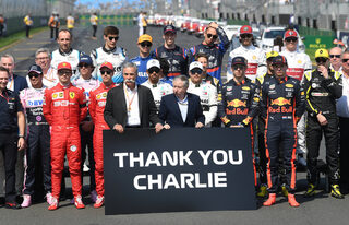 Drivers and officials are seen alongside a sign saying "Thank You Charlie" as a tribute to Charlie Whiting who died earlier this week, during the Formula One F1 Australian Grand Prix at the Albert Park Grand Prix Circuit in Melbourne