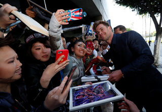 Cast member Chris Hemsworth poses with fans on the red carpet at the world premiere of the film "The Avengers: Endgame" in Los Angeles