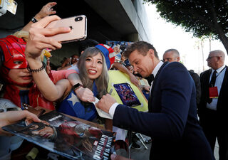 Cast member Jeremy Renner signs autographs for fans on the red carpet at the world premiere of the film "The Avengers: Endgame" in Los Angeles