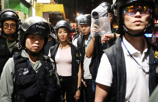 Police officers arrive to conduct a check on the first aid responders in Sai Ying Pun in Hong Kong