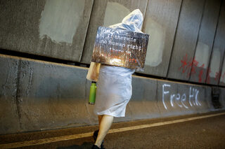 Anti-extradition bill protester carries a placard during a rally in Hong Kong