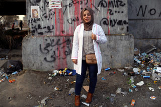 Rand Mohammad, a medical volunteer, poses for a photograph during the ongoing anti-government protests in Baghdad