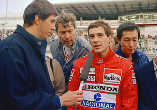 Senna answers questions from a reporter after practice for the Formula One Japan Grand Prix at the Suzuka Circuit in central Japan, Oct. 29, 1988. Senna took the pole position.jpg