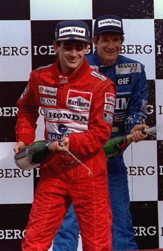 Senna of Brazil, left, winner of the Phoenix Iceberg Grand Prix, and third place finisher Thierry Boutsenof of Belgium shake a bottle of champagne during awards ceremonies March 12, 1990.jpg