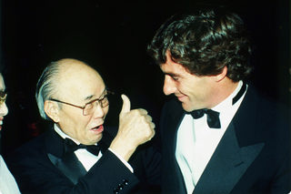 Soichiro Honda , left, gives a thumbs-up congratulations to Brazilian race driver Ayrton Senna after he aws awarded the 1990 Formula One World Championship trophy in Paris on Dec. 7. Senna raced.jpg