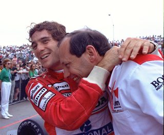 Senna happily hugs McLaren director Ron Dennis after won the US GP in Phoenix March 11, 1991. Senna, the defending race and world champion and top qualifier, led from start to finnish.jpg