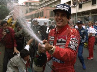 Senna sprays champagne on the photographers to celebrate his career\'s 30th victory at the Monaco Formula One Grand Prix May 12, 1990.jpg